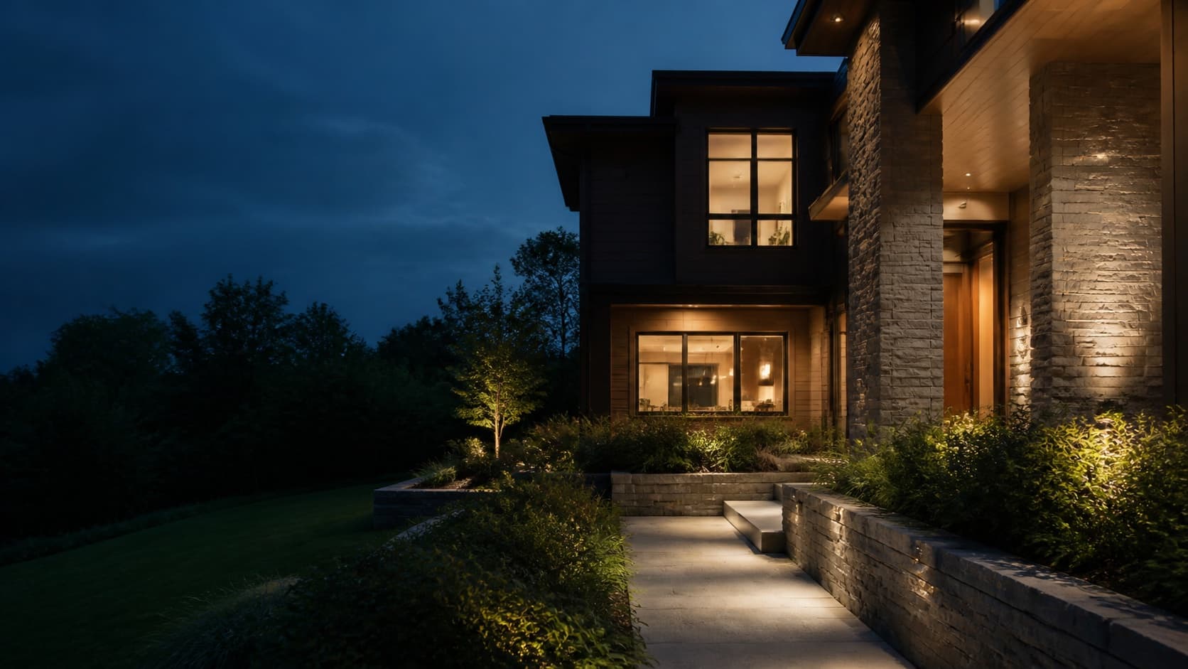 A contemporary rental home at blue hour with warm interior light