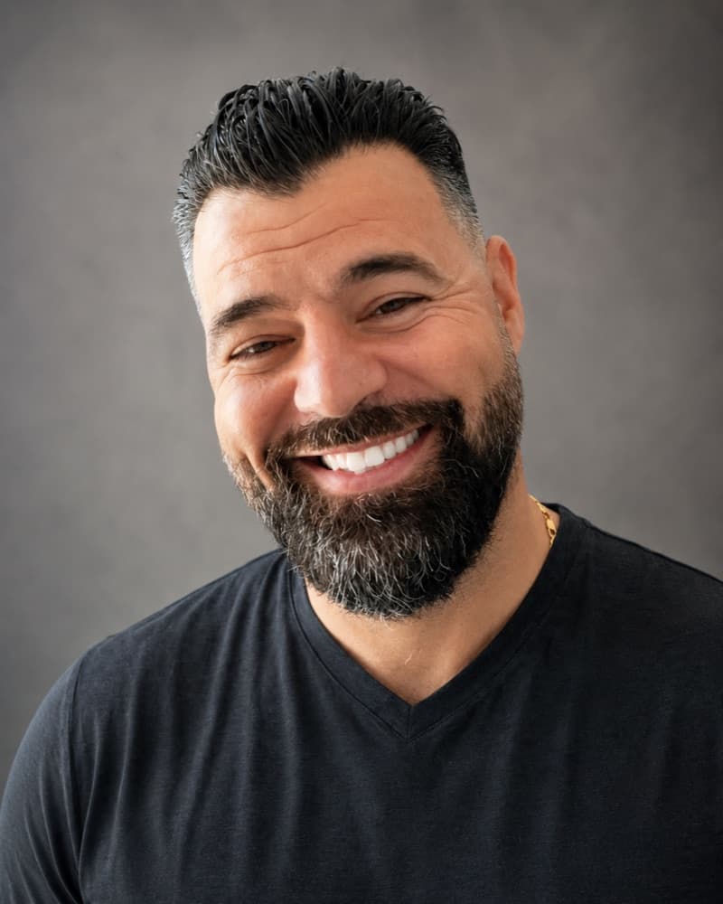 Verde Homes founder smiling in a black shirt